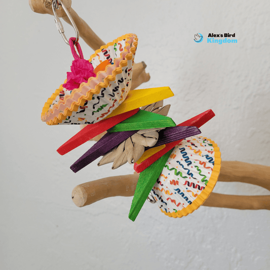 Colorful handmade Chew N’ Play bird toy with palm leaf, wood blocks, and cupcake liners for small parrots like budgies and cockatiels